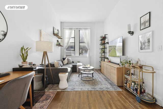 living room featuring visible vents and wood finished floors