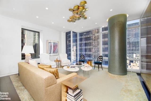 living room featuring hardwood / wood-style flooring and a wall of windows