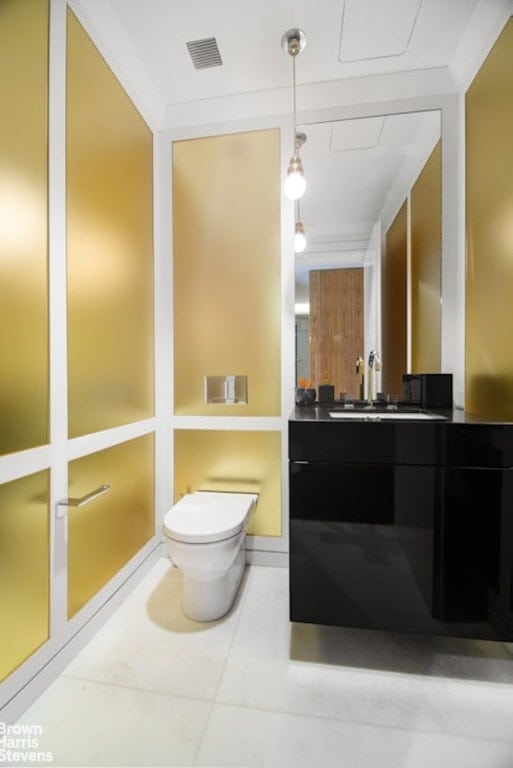 bathroom with vanity, tile patterned flooring, ornamental molding, and toilet