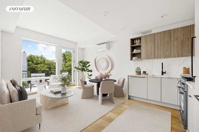 living area featuring recessed lighting, light wood-style flooring, visible vents, and a wall mounted AC