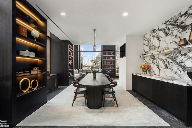 dining area with a wall of windows and recessed lighting