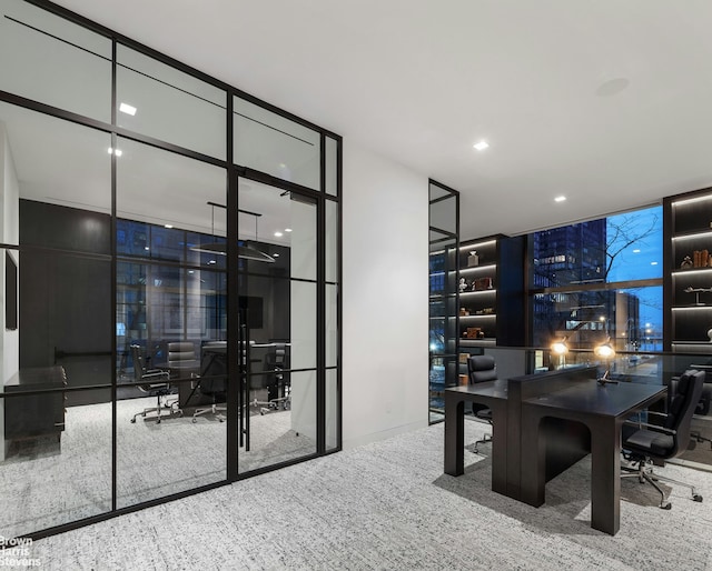 office area featuring floor to ceiling windows and carpet floors