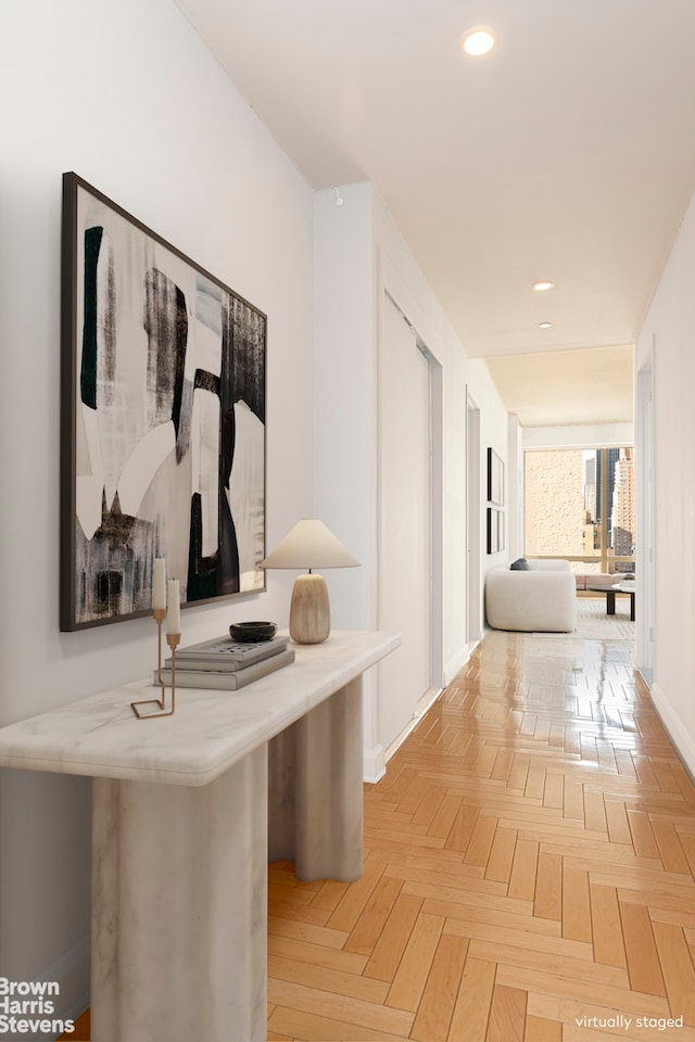 hall with recessed lighting and baseboards