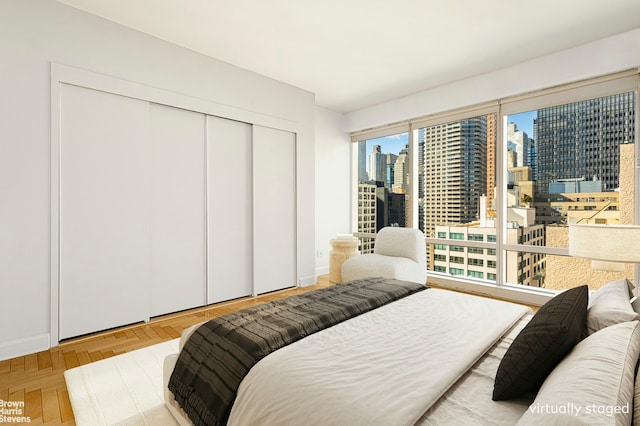 bedroom with a closet and a view of city