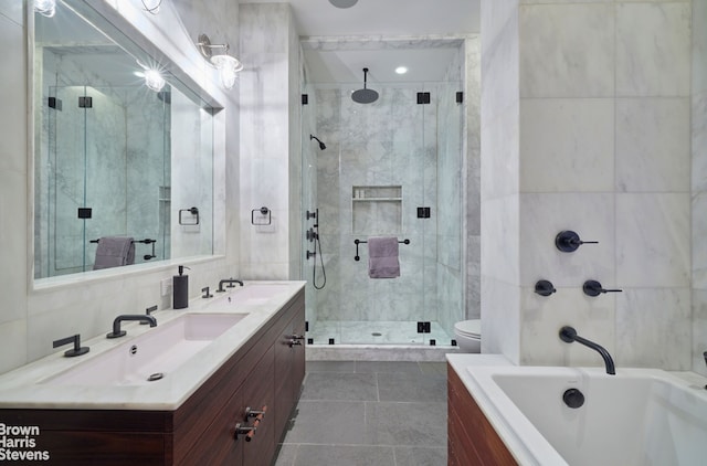 bathroom featuring a tub to relax in, a sink, and tile walls