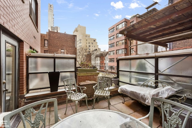 balcony featuring a patio area and a city view