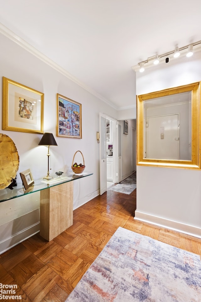 corridor with baseboards and crown molding