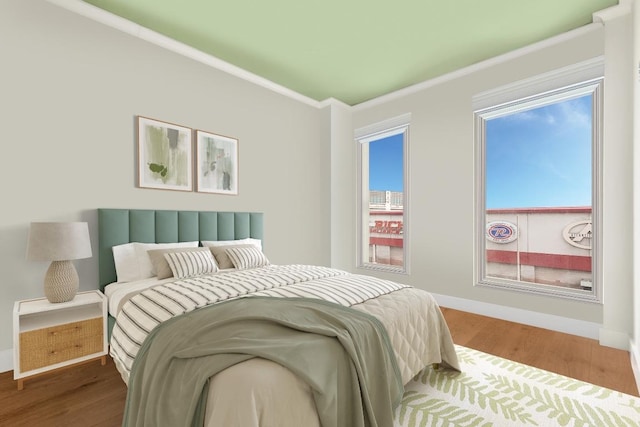 bedroom with crown molding and hardwood / wood-style flooring