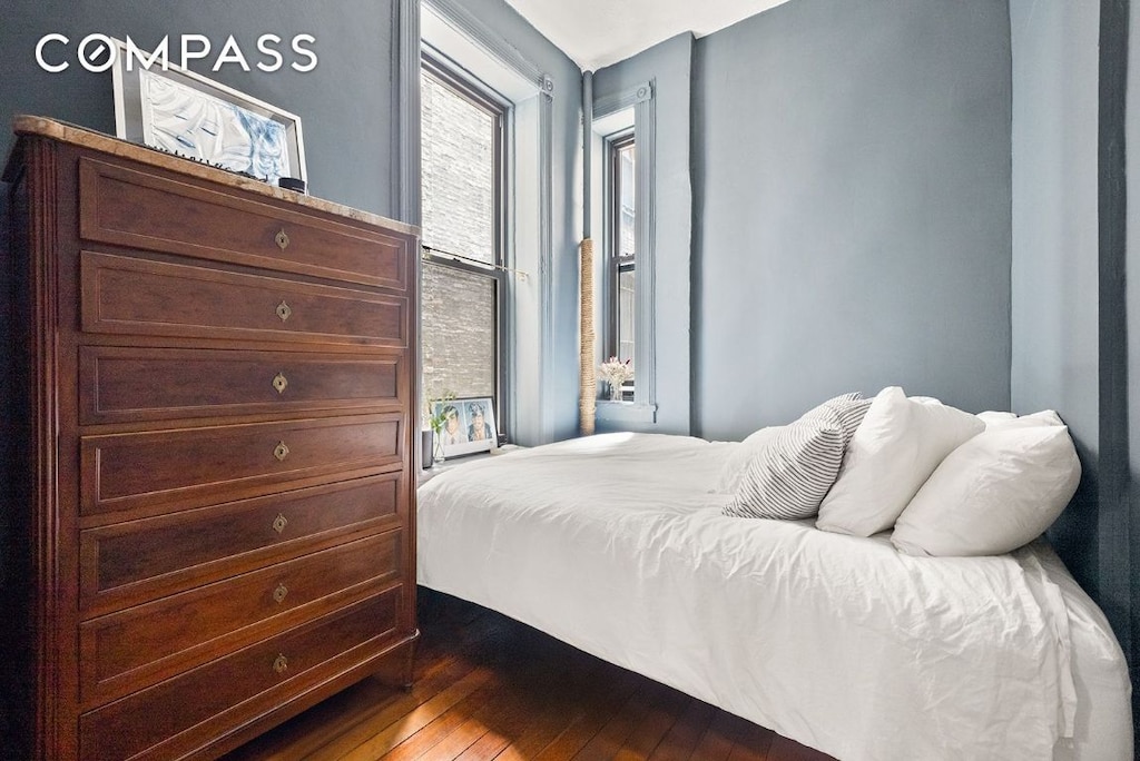 bedroom with dark wood-style floors