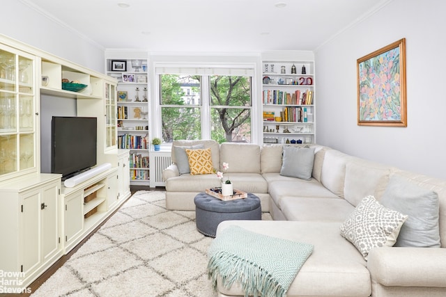 living area with built in features and crown molding