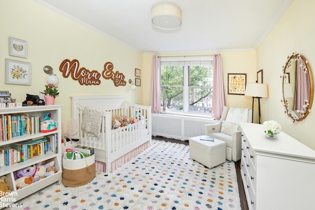 64 E 94th St Unit 3C, New York City, NY 10128 - bedroom featuring radiator, crown molding, and a nursery area