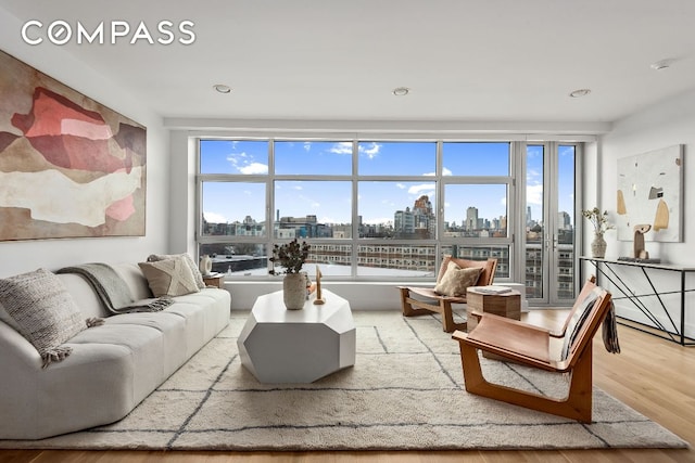 living room with wood finished floors and a city view