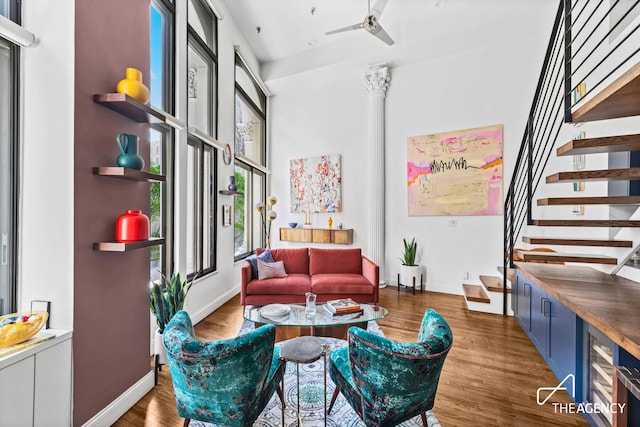 sitting room featuring stairway, baseboards, and wood finished floors