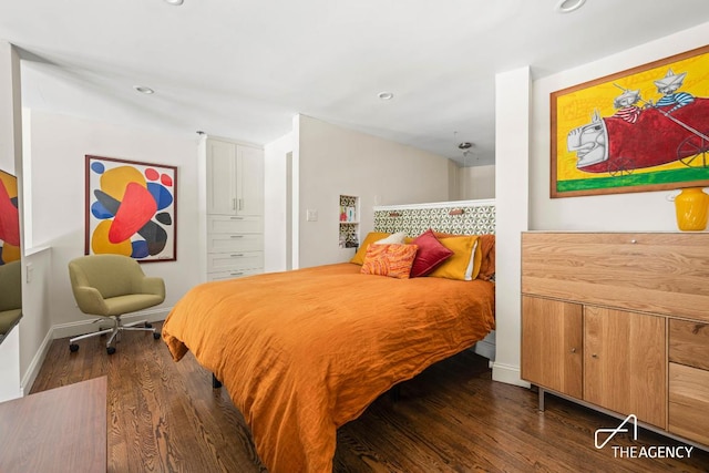 bedroom featuring baseboards, dark wood-style flooring, and recessed lighting