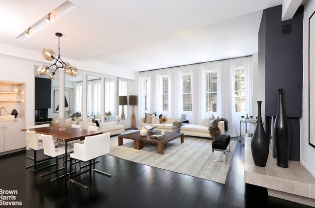 81 White St Phe, Phe, New York City, NY 10013 - living area with healthy amount of natural light, a chandelier, and wood finished floors