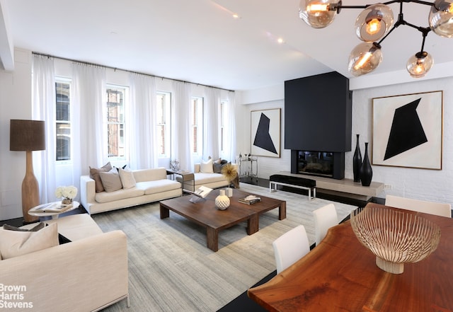 living area featuring a glass covered fireplace and recessed lighting