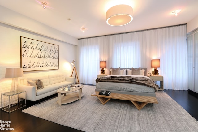 bedroom with dark wood-type flooring