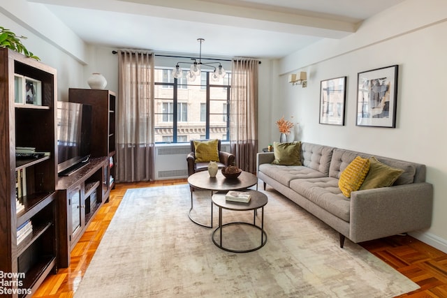 living room with a notable chandelier, beam ceiling, radiator heating unit, and light parquet flooring