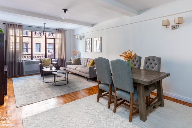 dining space with light parquet floors, radiator, a notable chandelier, and beam ceiling