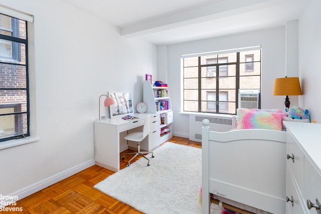 bedroom with cooling unit, radiator heating unit, and light parquet floors