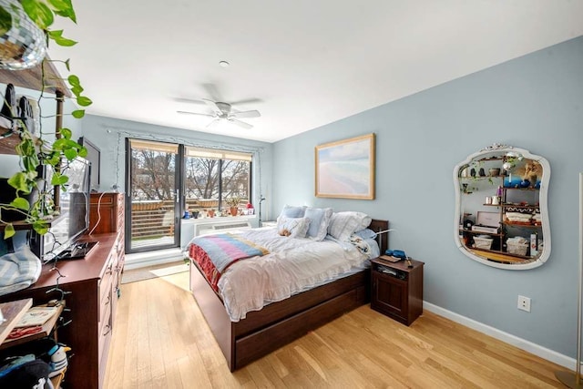 bedroom with ceiling fan, baseboards, and light wood-style floors