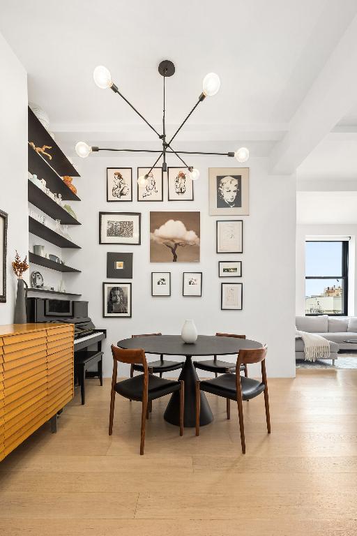 dining area featuring a chandelier and light wood-type flooring