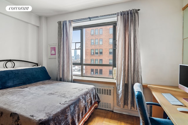 bedroom featuring radiator heating unit and visible vents