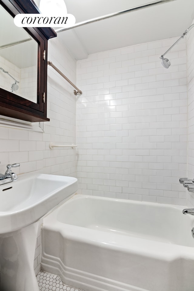 130 8th Ave Unit 7D, New York City, NY 11215 - bathroom with bathtub / shower combination, tile walls, tile patterned flooring, backsplash, and a sink