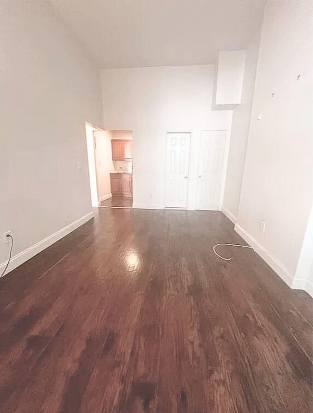 spare room with wood finished floors and baseboards