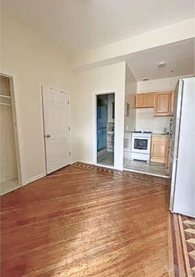unfurnished living room featuring wood finished floors