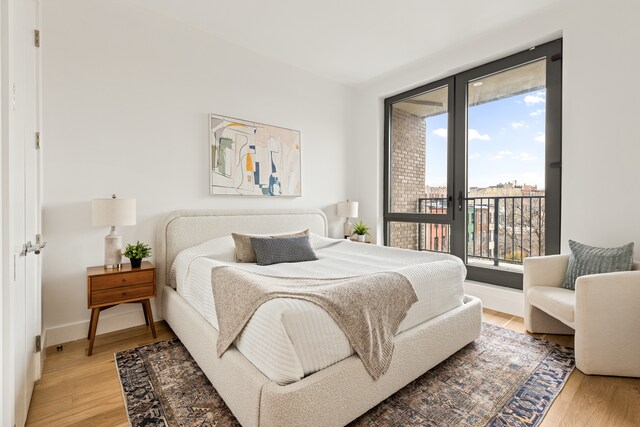 450 Grand Ave Unit 4A, New York City, NY 11238 - bedroom featuring access to outside, light wood-style flooring, and baseboards