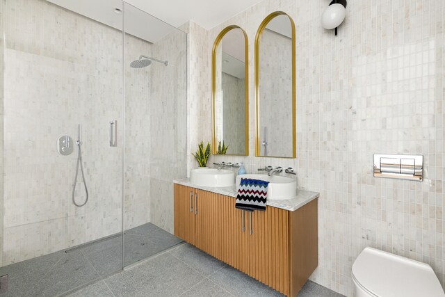 450 Grand Ave Unit 4A, New York City, NY 11238 - full bath with tile walls, a walk in shower, double vanity, and toilet