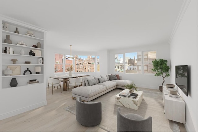 living room featuring a notable chandelier, light wood finished floors, baseboards, and crown molding