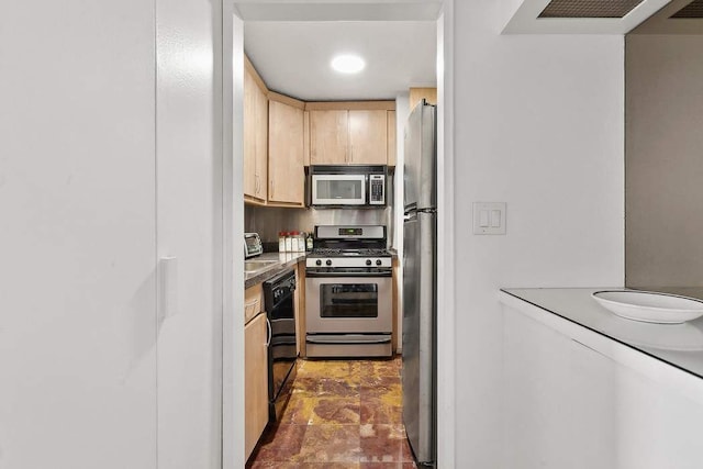 kitchen with stainless steel appliances and light brown cabinets