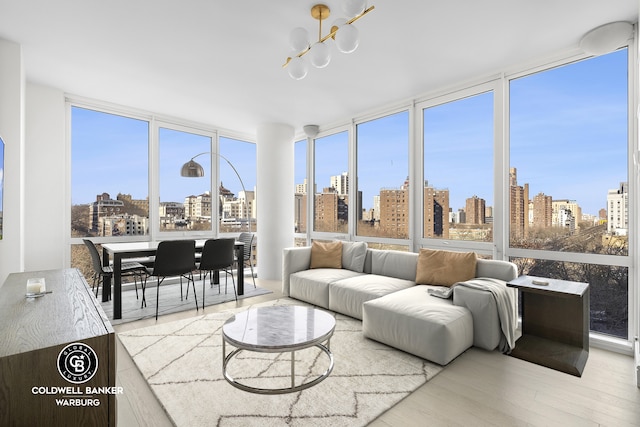 sunroom / solarium with a city view and an inviting chandelier