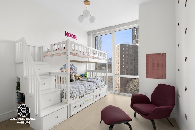 1399 Park Ave Unit 8D, New York City, NY 10029 - bedroom with wood finished floors and a city view