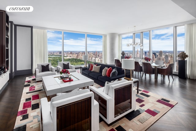 living room with an inviting chandelier, a wall of windows, dark parquet flooring, and a wealth of natural light