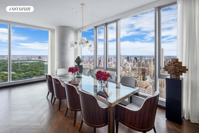 dining area with expansive windows and dark parquet floors