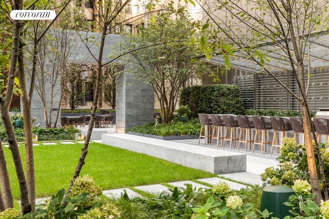 view of property's community with a yard and a patio