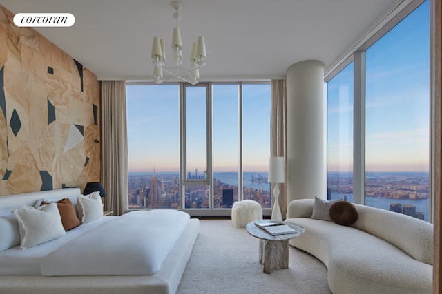 bedroom featuring expansive windows, carpet floors, and a notable chandelier