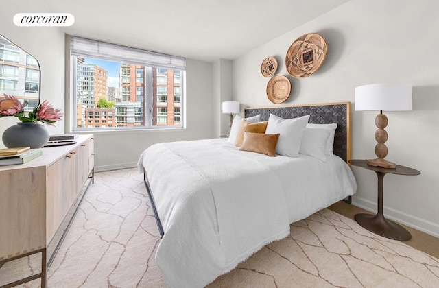 bedroom with a city view, visible vents, and baseboards