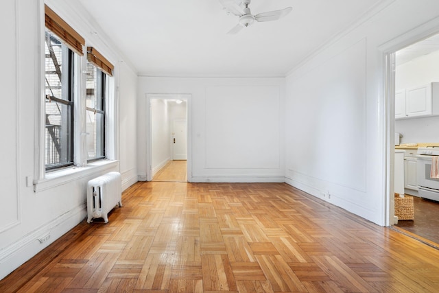 spare room featuring radiator and a ceiling fan