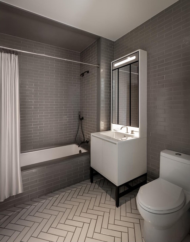 959 1st Ave Unit 15D, New York City, NY 10022 - bathroom featuring tiled shower / bath, toilet, vanity, and tile walls