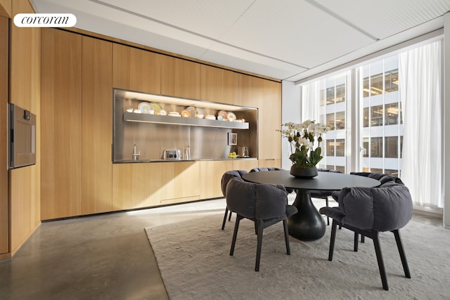 100 E 53rd St Unit 5A, New York City, NY 10022 - dining space with concrete floors and wooden walls