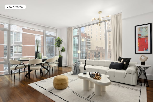 living area featuring an inviting chandelier, hardwood / wood-style flooring, floor to ceiling windows, and visible vents