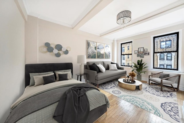 bedroom with baseboards, wood-type flooring, ornamental molding, and beam ceiling