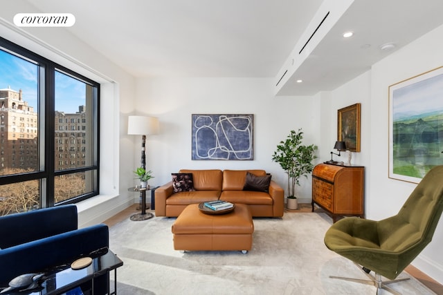 living room with a view of city, visible vents, baseboards, and recessed lighting