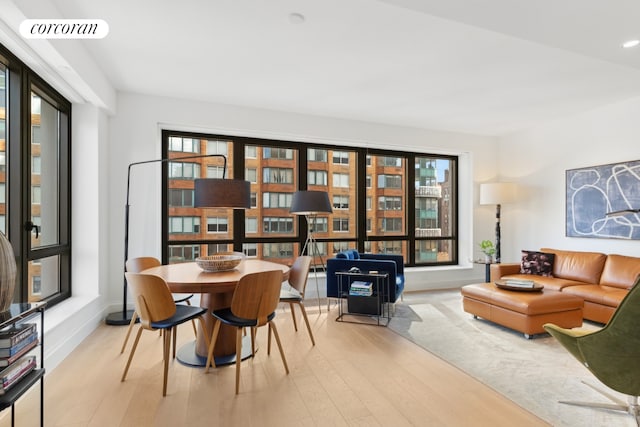 sitting room with baseboards, visible vents, wood finished floors, and recessed lighting