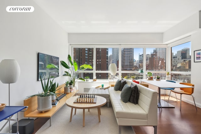 living room with a view of city, visible vents, and wood finished floors