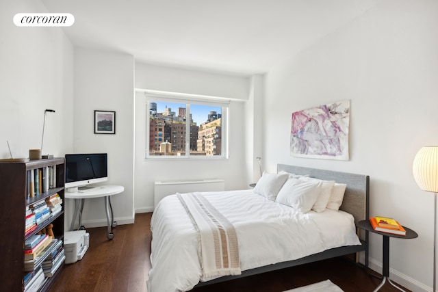 bedroom featuring baseboards, visible vents, and dark wood finished floors